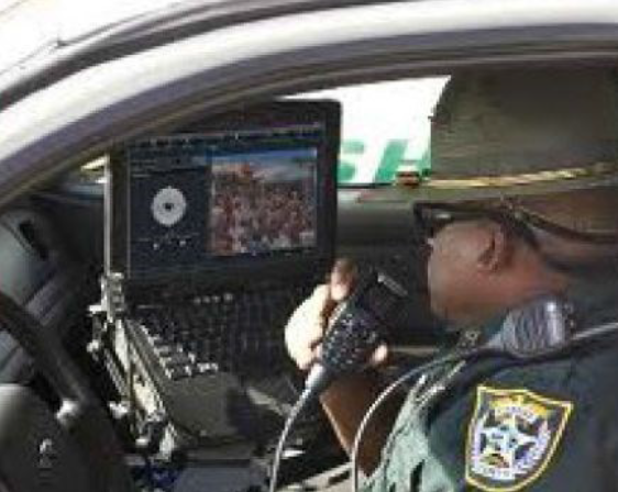 Policeman Using MDT in Patrol Car